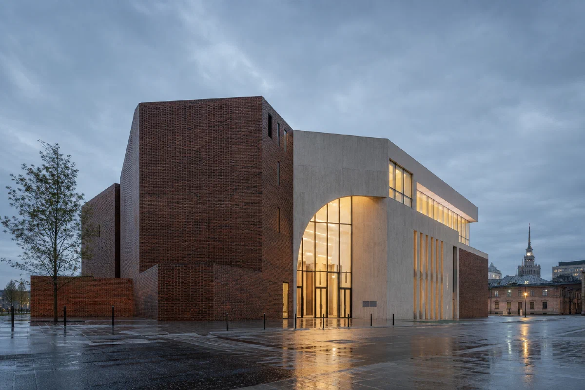 Conceptual contemporary brick and concrete cultural building in Warsaw at blue hour